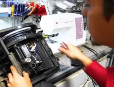 Vacuum repair technician servicing internal components on a workbench in Jackson, MS